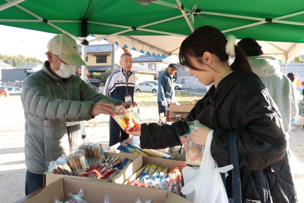 食品を手渡す津山「きぼう市」実行委のスタッフ