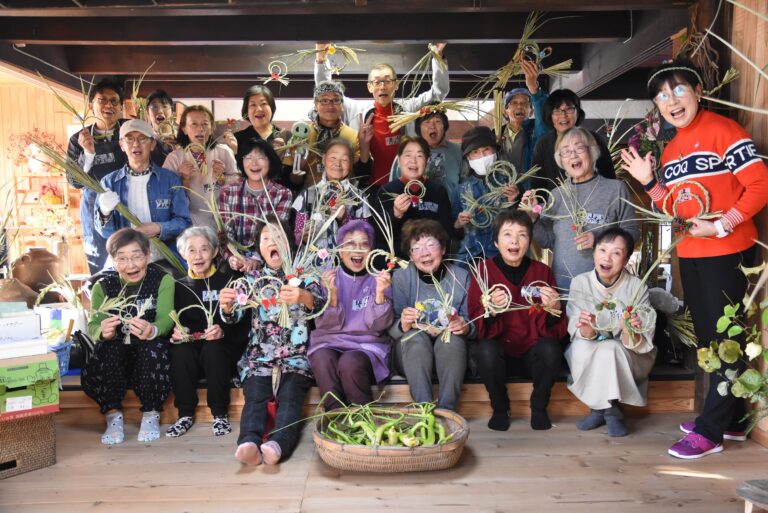 仕上がったマコモの飾りを手にする参加者=岡山県津山市で