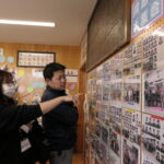 写真を見ながら思い出話に花を咲かせる卒業生ら