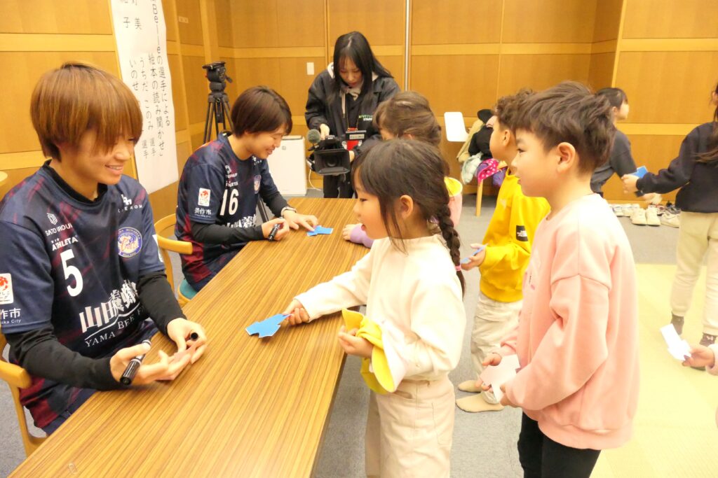 選手からサインをもらう園児たち