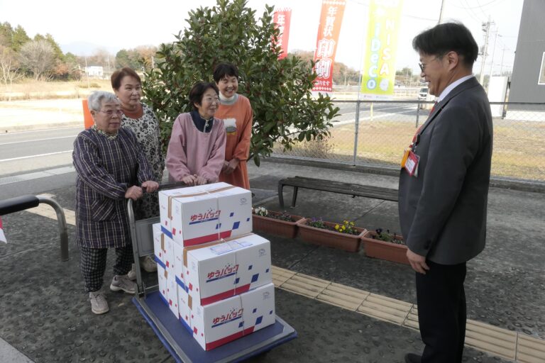 荒田局長に寄贈の黒豆煮を渡すメンバー=岡山県勝央町で