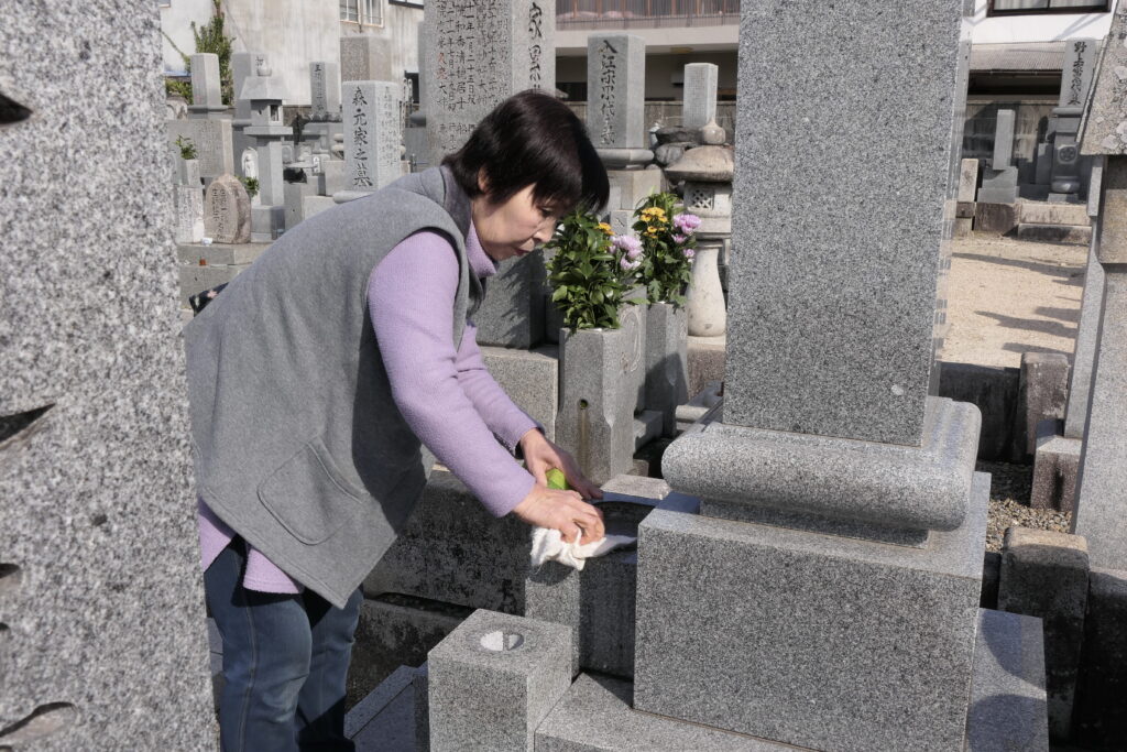 先祖の墓をきれいにし、供養に訪れた人