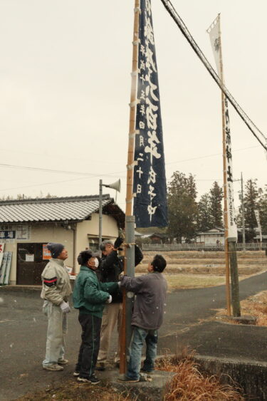 のぼり旗を立てて参拝者を迎える準備を進める氏子たち=岡山県津山市で