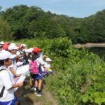 ため池を見学する児童=岡山県津山市で