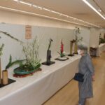 絵画や生け花などの展示作に見入る来場者=岡山県津山市で