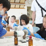 鑑識体験をする家族連れ=岡山県津山市で