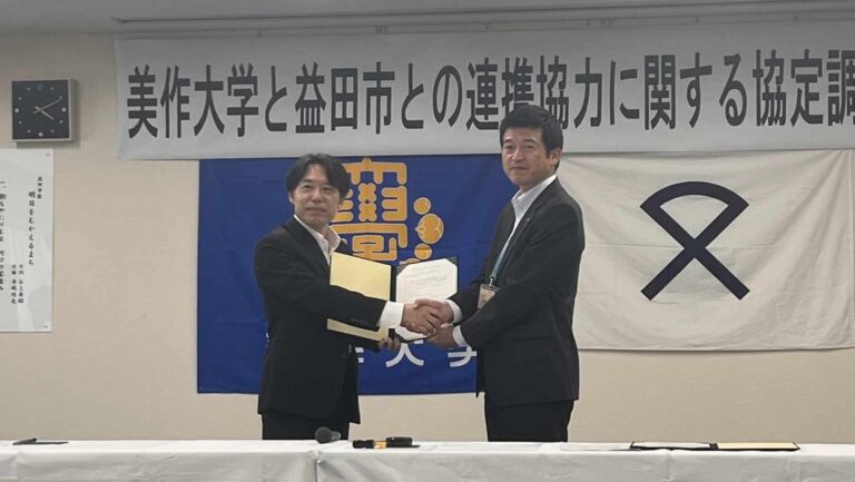 握手を交わす桐生学長と山本市長（右）=島根県益田市で