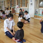 園児と向き合い、遊びを通して保育の仕事を体験する高校生たち＝岡山県勝央町で