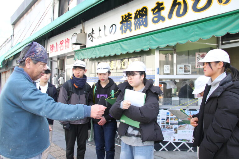 佐古さんから説明を受ける6年生=岡山県津山市、味よしで