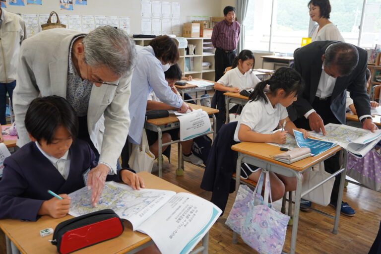 高田地域の河川や水路の場所を教わる児童たち=岡山県津山市で