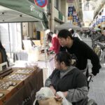 ネコグッズや菓子を買い求める人でにぎわう商店街=岡山県津山市で