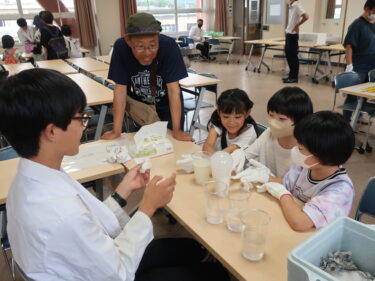 ドライアイスを使った実験に目を輝かせる小学生=岡山県津山市で