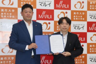 協定書を手にする松田社長（左）と桐生学長=岡山県津山市で