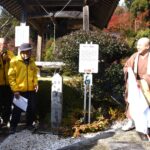 除幕をして新たな看板の設置を祝う参加者=岡山県津山市で