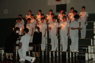 ナイチンゲール像の灯を移したろうそくを手に整列していく38期生=岡山県津山市で