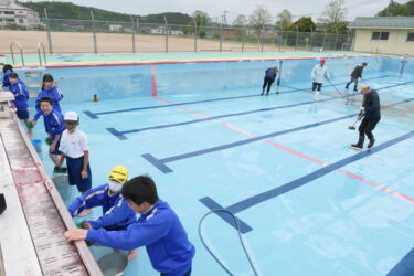 地域ボランティアとプール掃除に励む生徒たち=岡山県美作市で