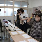 ヘルメットを試着し、着け心地を確かめる一般来場者