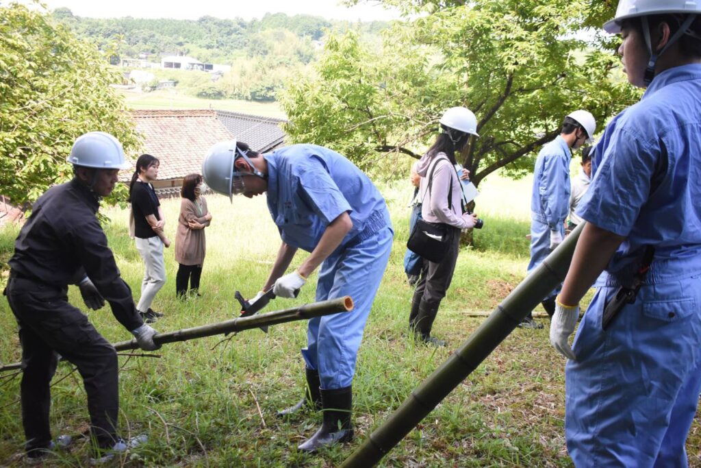 切り出した竹を切る生徒