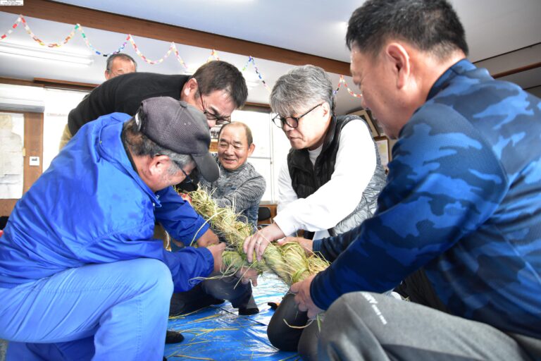 小縄をねじり合わせて大縄をつくる参加者=岡山県津山市で